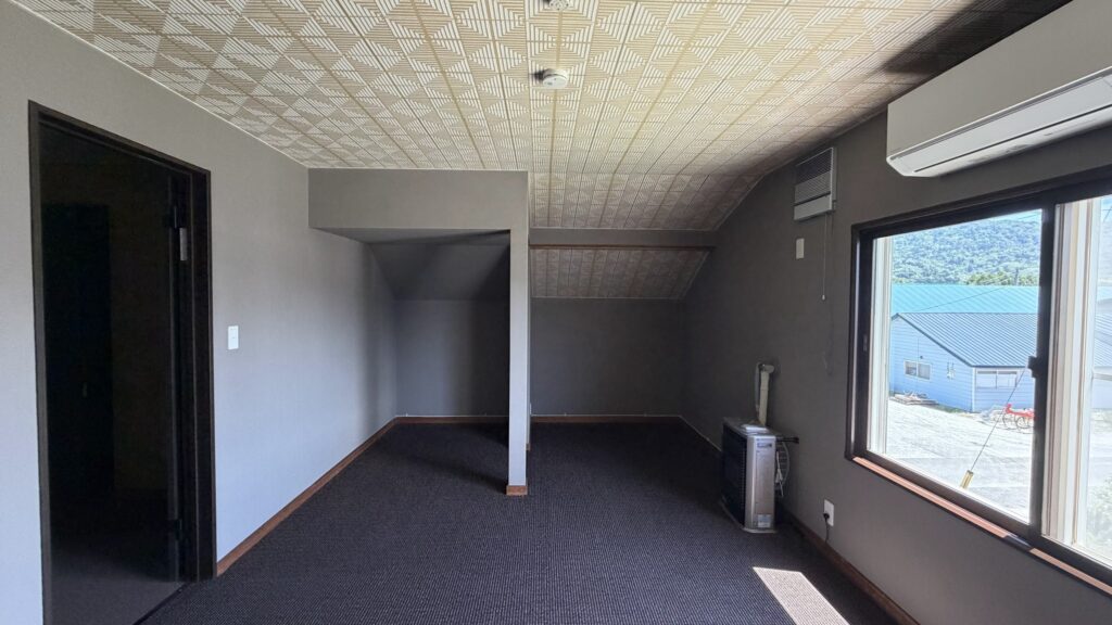 富良野山部のフルリノベ済みキャビン内装。絨毯と幾何学模様天井の部屋。旅館業取得済み物件。